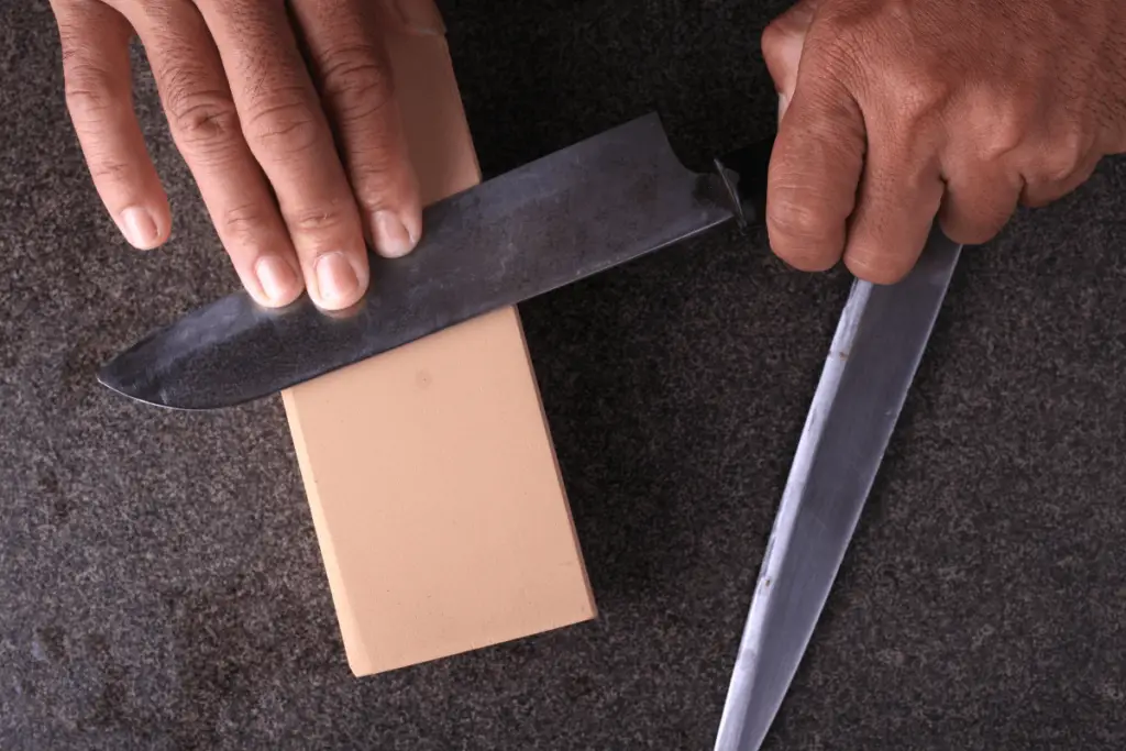 Using a whetstone to sharpen a knife